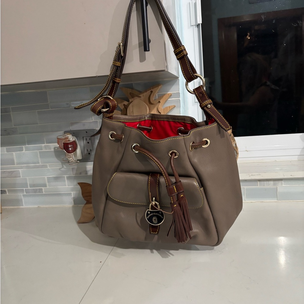 Shoulder Bag dooney amd Bourke missing one of the side gold button see pics.